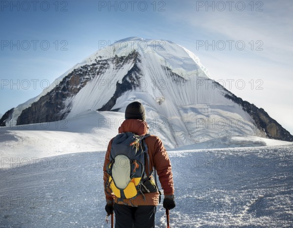 Lone climber equipped with winter gear trekking through pristine snow towards a towering mountain peak under vibrant sunlight, AI generated