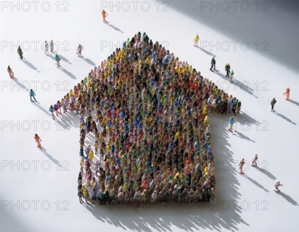 A concept photograph depicting numerous individuals arranged to form the shape of a house. Symbolic representation of community, shelter, cooperation, and housing solutions in a creative visual format, AI generated