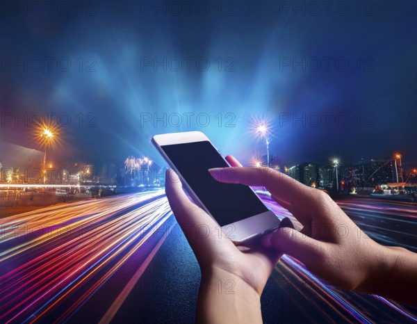 Hand holding a smartphone with a blank screen above a motion-blurred, colorful light background, AI generated