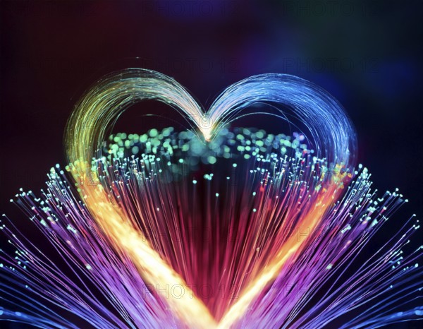 Colorful artistic display featuring vibrant light patterns shaped like a heart, expressing love and creativity through illuminated fibers in a mesmerizing spectrum of rainbow hues, AI generated