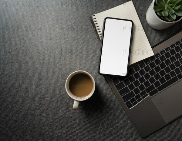 Op view of an organized workspace featuring a laptop, smartphone, notebook, pen, plant, and coffee emphasizing minimalism, productivity, modern work environments, AI generated
