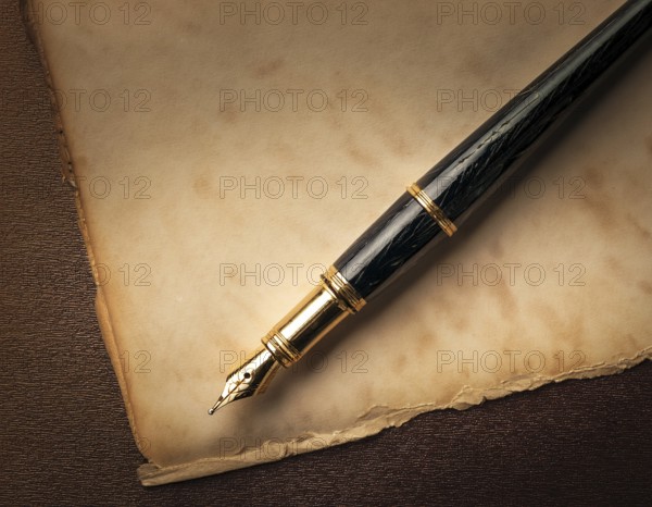Close-up of a classic fountain pen lying atop old aged paper on a wooden surface, symbolizing timeless writing, creativity, and tradition, AI generated