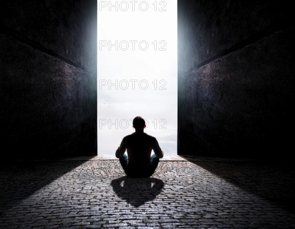 Silhouette of a person sitting alone within a brick archway, observing a peaceful and scenic cloudy horizon, evoking feelings of solitude, introspection, and calmness, AI generated