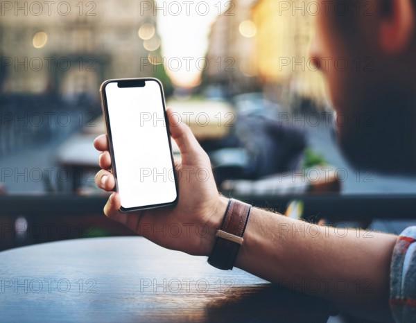 A person holding a smartphone at an outdoor cafe amidst a vibrant and lively urban setting. The image captures a relaxed moment with modern technology interaction and a scenic cityscape, AI generated