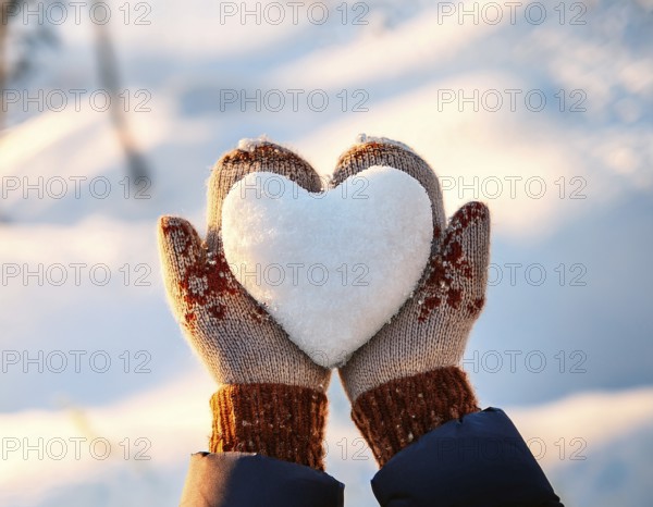 Serene winter scene showcasing hands in gloves holding a snow heart symbolizing love and warmth, AI generated