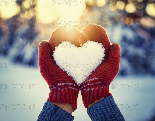 Serene winter scene showcasing hands in gloves holding a snow heart symbolizing love and warmth, AI generated