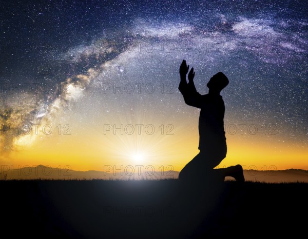 A man kneels in peaceful reflection under the vibrant Milky Way galaxy at sunset in an open natural setting, making prays, AI generated