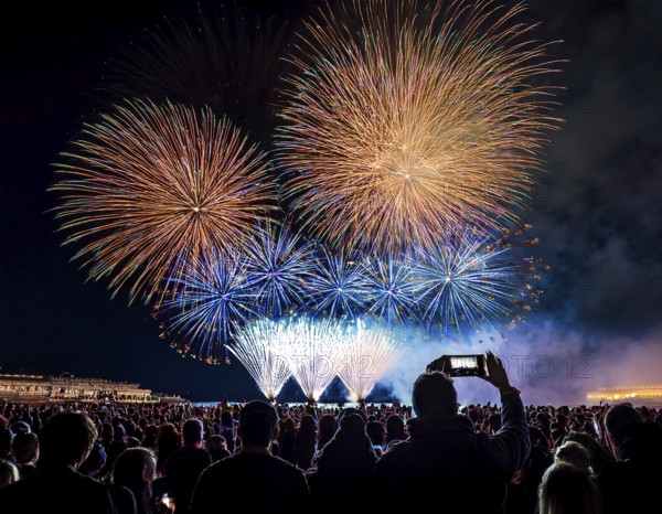 Thrilling fireworks illuminate the dark sky as a crowd gathers to enjoy the dazzling display, creating an atmosphere of festivity and wonder, AI generated