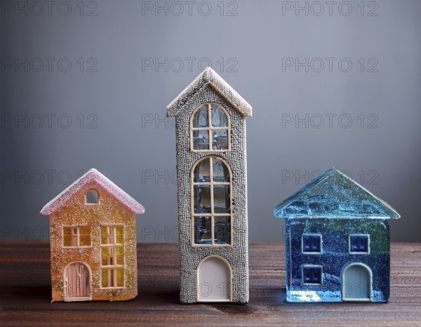 A collection of small glass model houses with cozy lighting, creating a warm and inviting atmosphere, AI generated