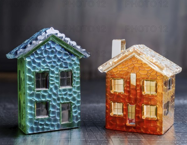 A collection of small glass model houses with cozy lighting, creating a warm and inviting atmosphere, AI generated
