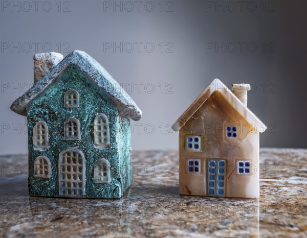 A collection of small model houses with cozy lighting, creating a warm and inviting atmosphere, AI generated