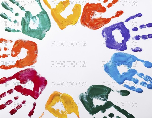 Brightly colored handprints in various hues arranged artistically on a textured white surface, evoking creativity, fun, and the spirit of collaboration or children's artistry, AI generated