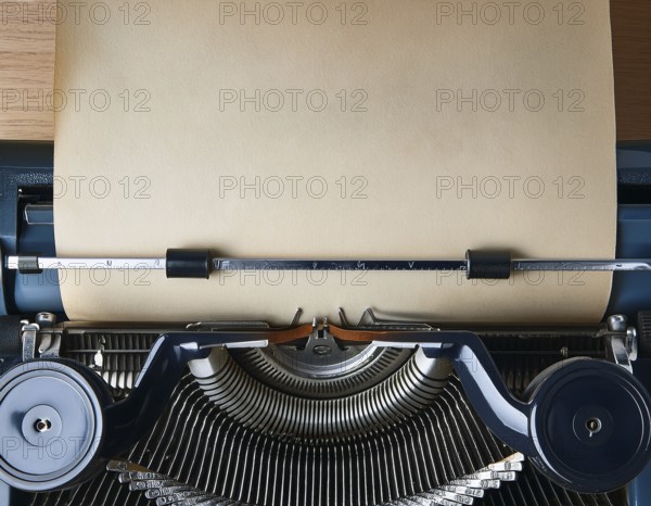 View from above of a retro typewriter equipped with a blank paper sheet, representing creativity, literary work, and nostalgia for traditional written communication methods, AI generated