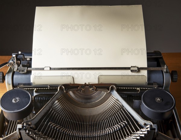 View from above of a retro typewriter equipped with a blank paper sheet, representing creativity, literary work, and nostalgia for traditional written communication methods, AI generated