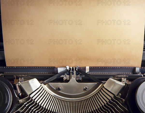 View from above of a retro typewriter equipped with a blank paper sheet, representing creativity, literary work, and nostalgia for traditional written communication methods, AI generated