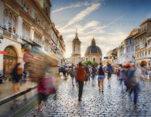 Historical city square with iconic architecture, cobblestone streets, and vibrant motion of pedestrians enjoying the surroundings, AI generated
