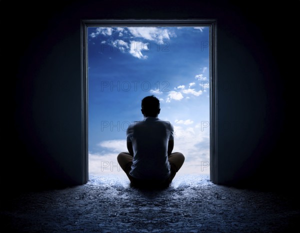 Silhouette of a person sitting alone within a brick archway, observing a peaceful and scenic cloudy horizon, evoking feelings of solitude, introspection, and calmness, AI generated