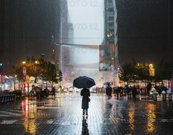 A solitary figure with an umbrella stands amidst a bustling city illuminated by lights, with reflections on the rain-soaked pavement creating a vibrant and atmospheric urban evening scene, AI generated