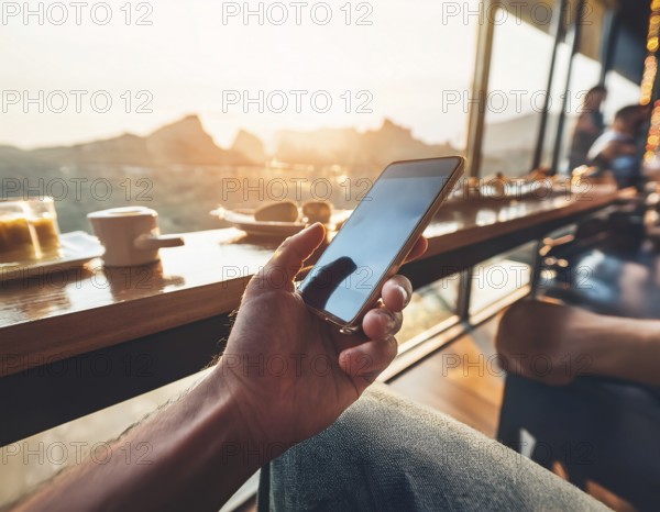 A person holding a smartphone at an outdoor cafe amidst a vibrant and lively urban setting. The image captures a relaxed moment with modern technology interaction and a scenic cityscape, AI generated