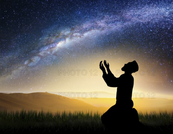 A man kneels in peaceful reflection under the vibrant Milky Way galaxy at sunset in an open natural setting, making prays, AI generated