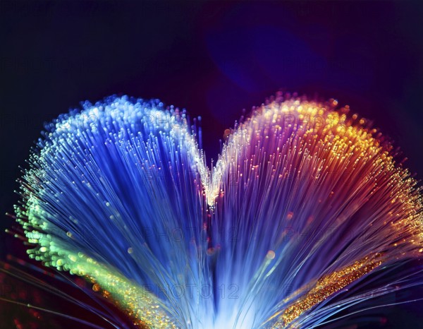 Colorful artistic display featuring vibrant light patterns shaped like a heart, expressing love and creativity through illuminated fibers in a mesmerizing spectrum of rainbow hues, AI generated
