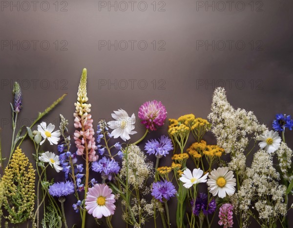 A variety of colorful wildflowers flourish on a hillside against a blurred mountainous backdrop. The flowers reflect vibrancy, serenity, and the beauty of nature in a peaceful outdoor environment, AI generated