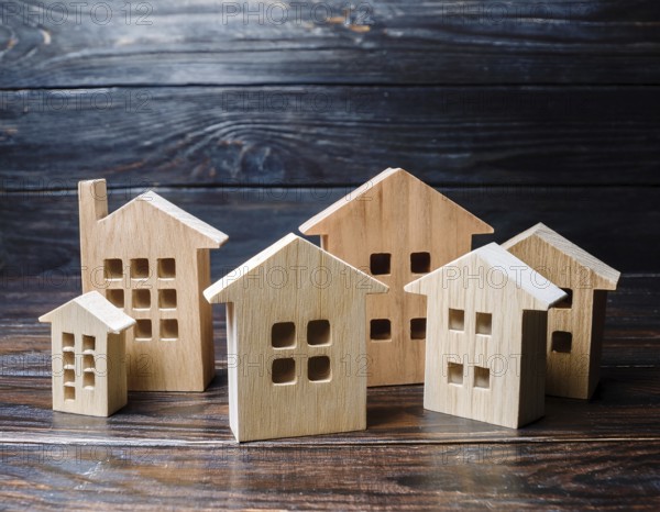 A collection of small wooden model houses with cozy lighting, creating a warm and inviting atmosphere, AI generated