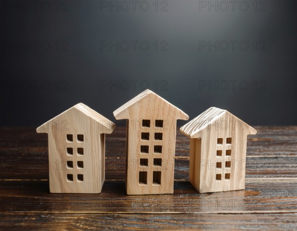 A collection of small wooden model houses with cozy lighting, creating a warm and inviting atmosphere, AI generated