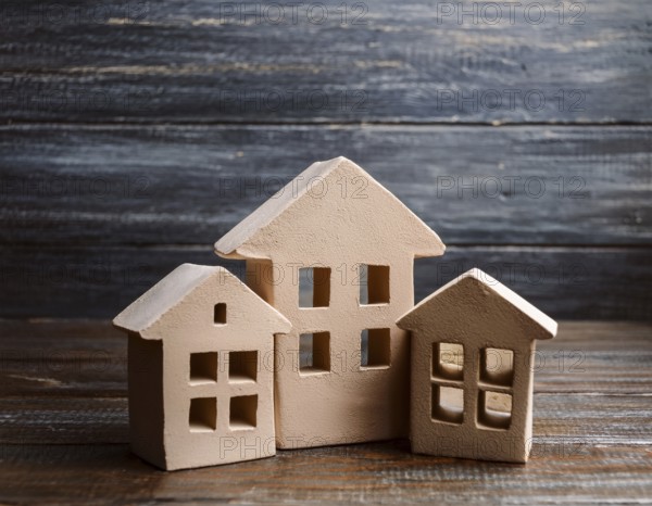 A collection of small model houses with cozy lighting, creating a warm and inviting atmosphere, AI generated