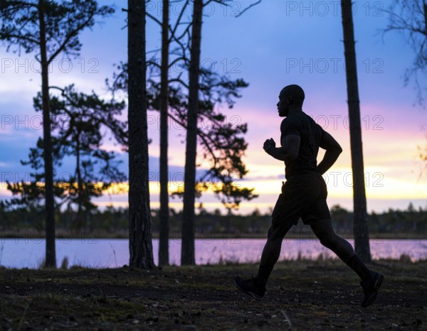 A cinematic silhouette of an athletic man running, representing fitness, endurance, wellness, and healthy active living, AI generated
