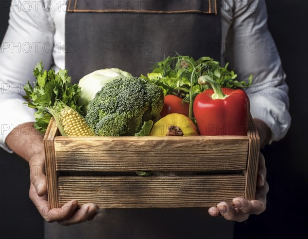 Man holding wooden crate with vegetables. Wooden box filled with fresh food products and ready for delivery, AI generated