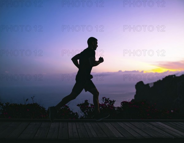A cinematic silhouette of an athletic man running, representing fitness, endurance, wellness, and healthy active living, AI generated