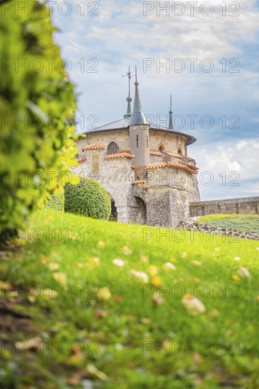 Charming turret on a green meadow in front of a slightly cloudy sky creates a romantic atmosphere, Lichtenstein Castle, Lichtenstein, Swabian Alb, Germany