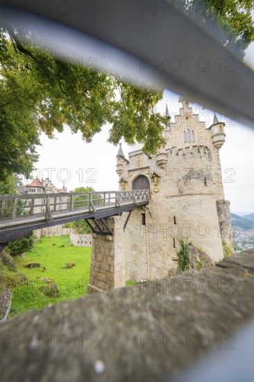 View through an opening onto a bridge leading to a castle, Lichtenstein Castle, Lichtenstein, Swabian Alb, Germany