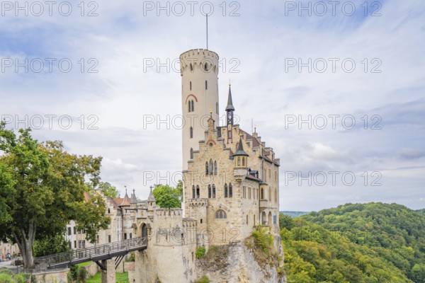 Medieval castle on a hill with green trees and blue sky, Lichtenstein Castle, Lichtenstein, Swabian Alb, Germany