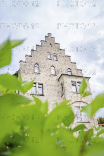 An impressive historic building in Gothic style, half hidden by green plants, Lichtenstein Castle, Lichtenstein, Swabian Alb, Germany