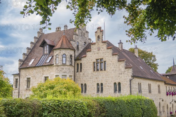 An old building with a red tiled roof and many windows, surrounded by trees, Lichtenstein Castle, Lichtenstein, Swabian Alb, Germany