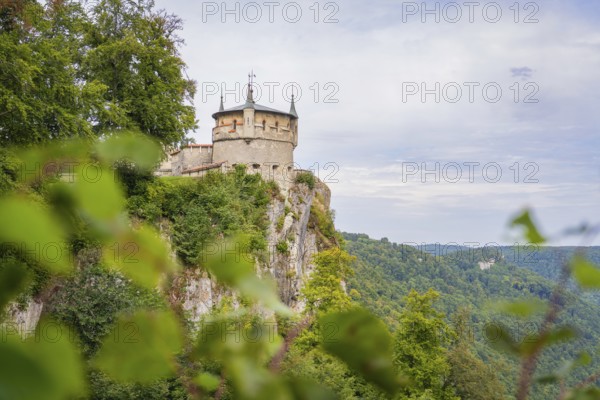 An impressive castle perched high on a cliff with sweeping views over the green landscape, Lichtenstein Castle, Lichtenstein, Swabian Alb, Germany