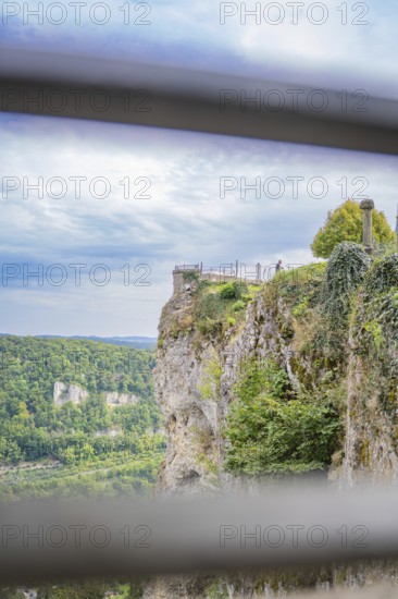 Spectacular cliff view with green landscape and wide sky in the background, captured from a railing perspective, Lichtenstein Castle, Lichtenstein, Swabian Alb, Germany