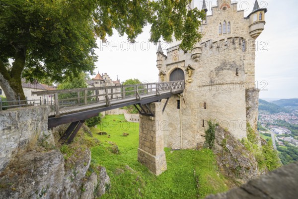 An impressive medieval castle on a rock with a wooden bridge over a green landscape, Lichtenstein Castle, Lichtenstein, Swabian Alb, Germany