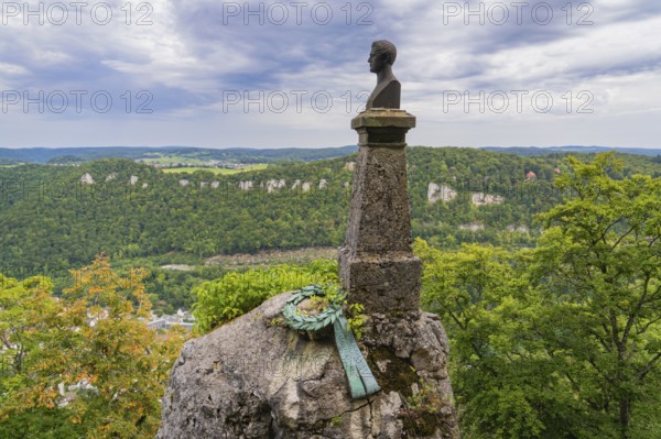 Bust on a rock with a view of the wide landscape and cloudy sky, Lichtenstein Castle, Lichtenstein, Swabian Alb, Germany