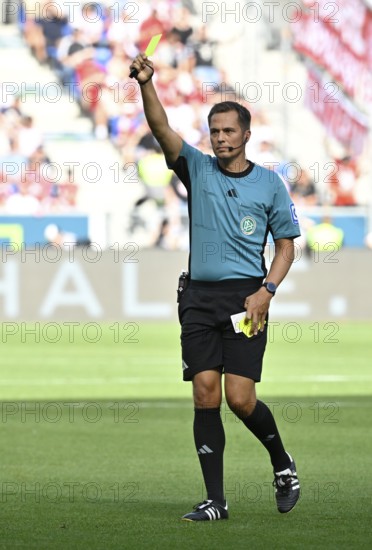 Referee Referee Robert Hartmann shows yellow card yellow caution Football Bundesliga, PreZero Arena, Sinsheim, Baden-Württemberg, Germany