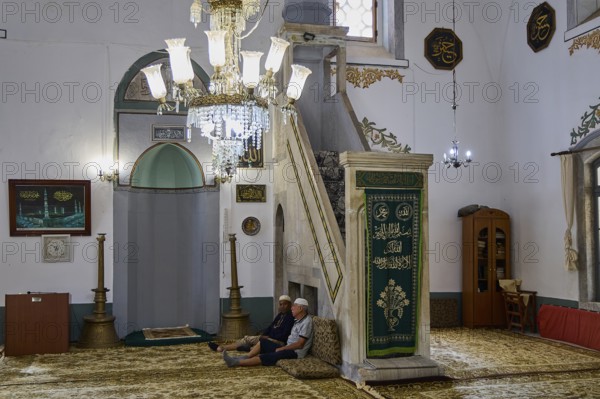 Mosque interior with seating and illuminated chandelier, Ibrahim Pasha Mosque, Old Town, Turkish Quarter, Rhodes Town, Rhodes, Dodecanese, Greek Islands, Greece