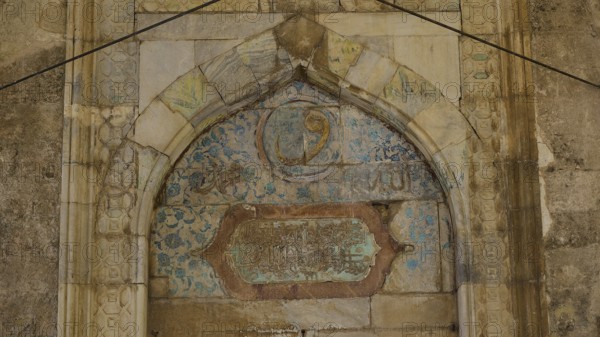 Decorated arch with faded inscriptions and ornaments on a stone background, Recep Pasha Mosque, Old Town, Turkish Quarter, Rhodes Town, Rhodes, Dodecanese, Greek Islands, Greece