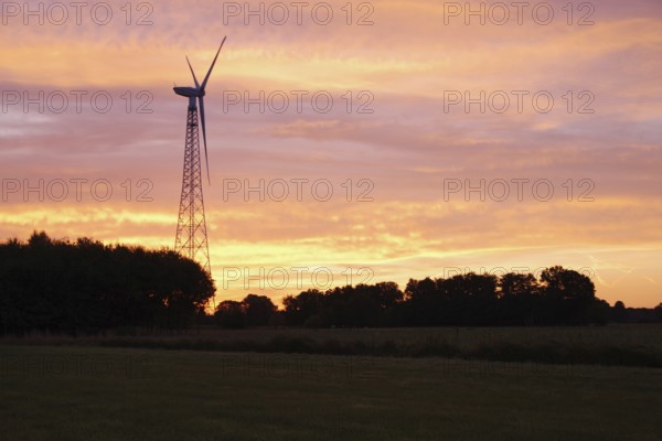 Wind generator, wind turbine, blades, sky, sunrise, landscape, electricity, colour, North Rhine-Westphalia, Germany, A single wind generator in a rural area in front of an orange-red sky