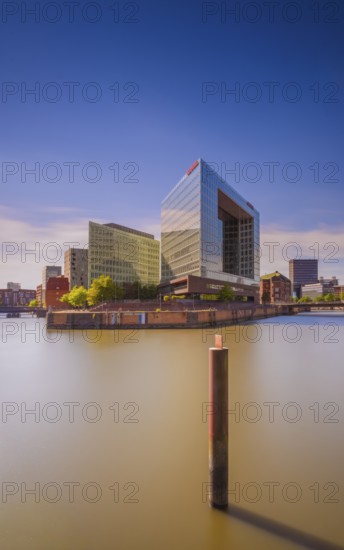 Long-term view of the Spiegel building at Oberehafen and Ericusgraben from the Oberhafen bridge with a steel dolphin in the foreground, Hamburg, Germany