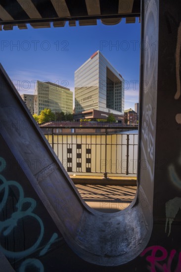 Long-term photograph of the mirror building through a steel girder of the Oberhafenbrücke bridge at Oberehafen and Ericusgraben, Hamburg, Germany