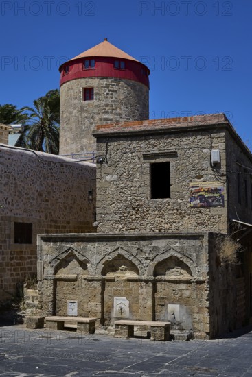 Washing facilities near Borsani Mosque, Turkish Quarter, Historic mill and ancient stone structure under a clear blue sky, Rhodes Old Town, Rhodes Town, Rhodes, Dodecanese, Greek Islands, Greece