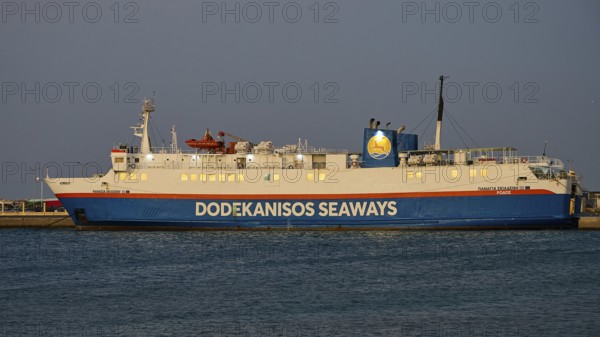A Dodekanisos Seaways ferry docks at dusk in the harbour by the calm sea, Rhodes Old Town, Rhodes Town, Rhodes, Dodecanese, Greek Islands, Greece