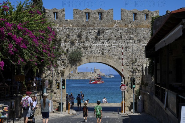 Panagia Tor, natural stone archway with a view of the sea and passing tourists, Rhodes Old Town, Rhodes Town, Rhodes, Dodecanese, Greek Islands, Greece